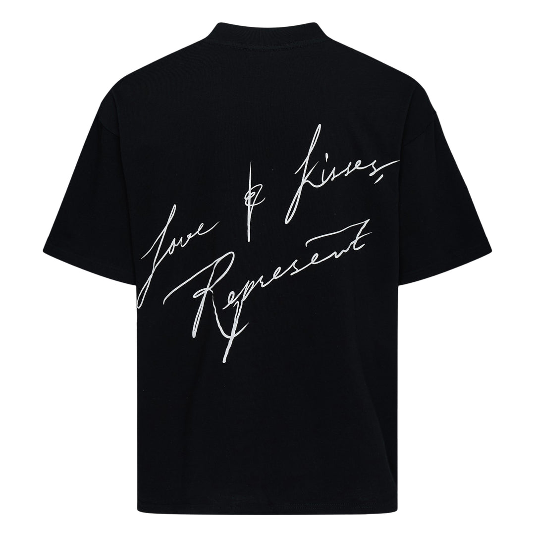 Back view of Represent Love & Kisses Tee in black, featuring a white cursive script graphic reading 'Love & Kisses, Represent' across the back