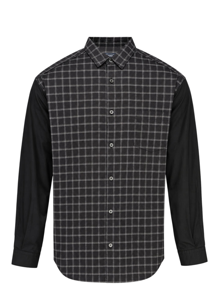 Comme des Garçons Homme long sleeve shirt with dark windowpane check cotton body and contrast solid black cotton broad cloth sleeves, shown flat on a white background