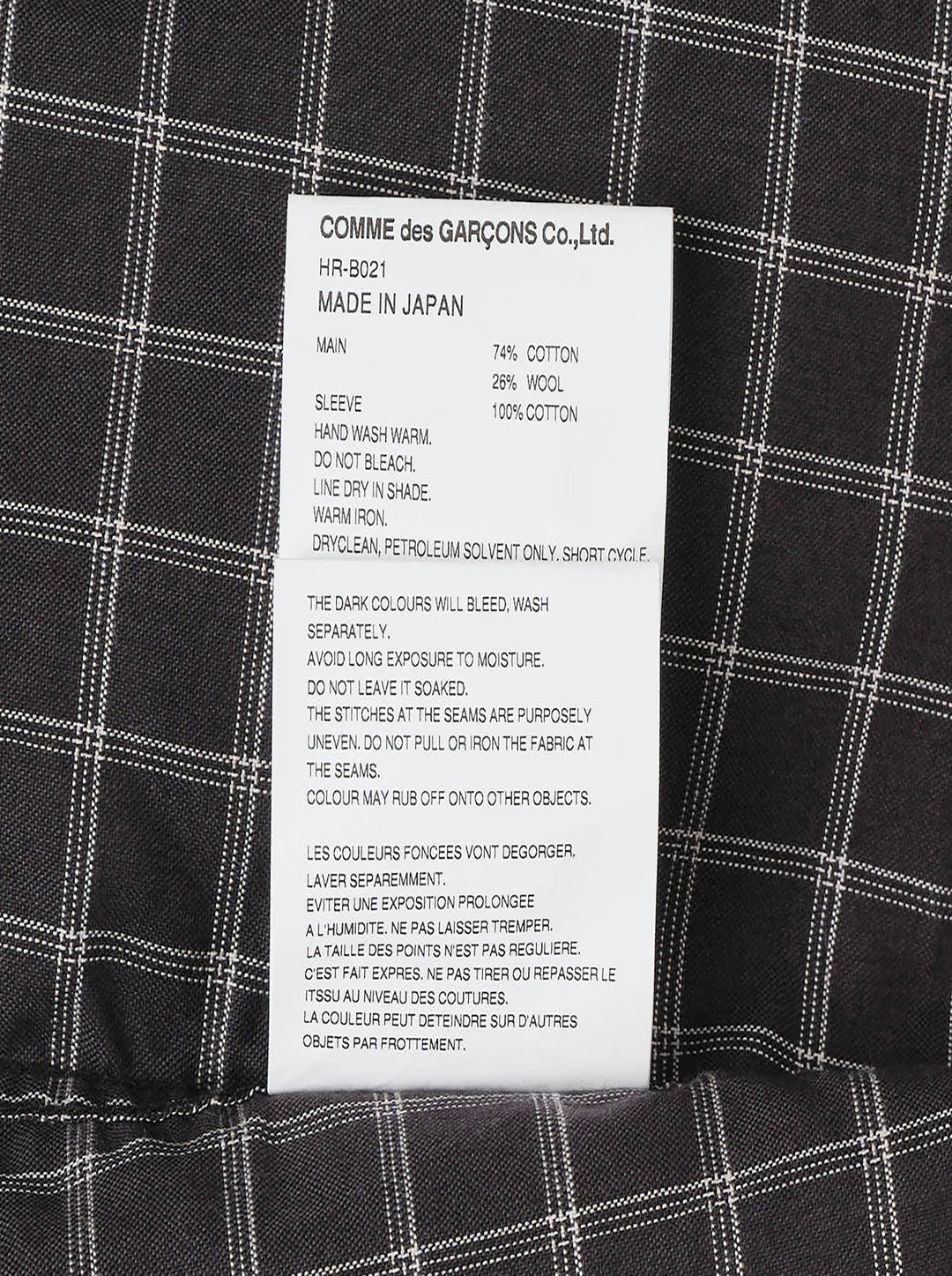 Comme des Garçons Homme long sleeve shirt with dark windowpane check cotton body and contrast solid black cotton broad cloth sleeves, shown flat on a white background - view 4