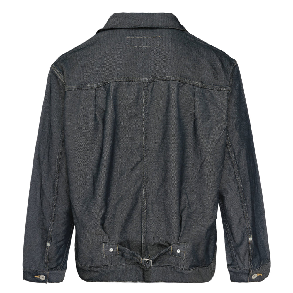 Comme des Garçons Homme polyester serge garment-dyed blouson in raw indigo, featuring contrast topstitching, mother-of-pearl snap buttons, and a single chest pocket with snap flap