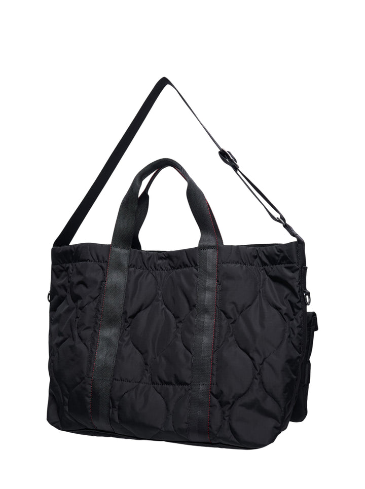 Comme des Garçons Homme black quilted nylon duck tote bag with four snap-fastened exterior pouches and webbing strap grid overlay, front view - view 2