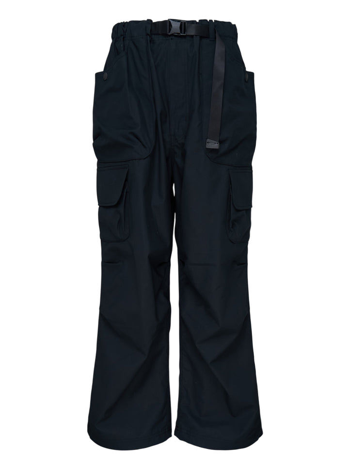 Black wide-leg cotton twill cargo pants with buckle webbing belt and flap utility pockets by Comme des Garçons Homme