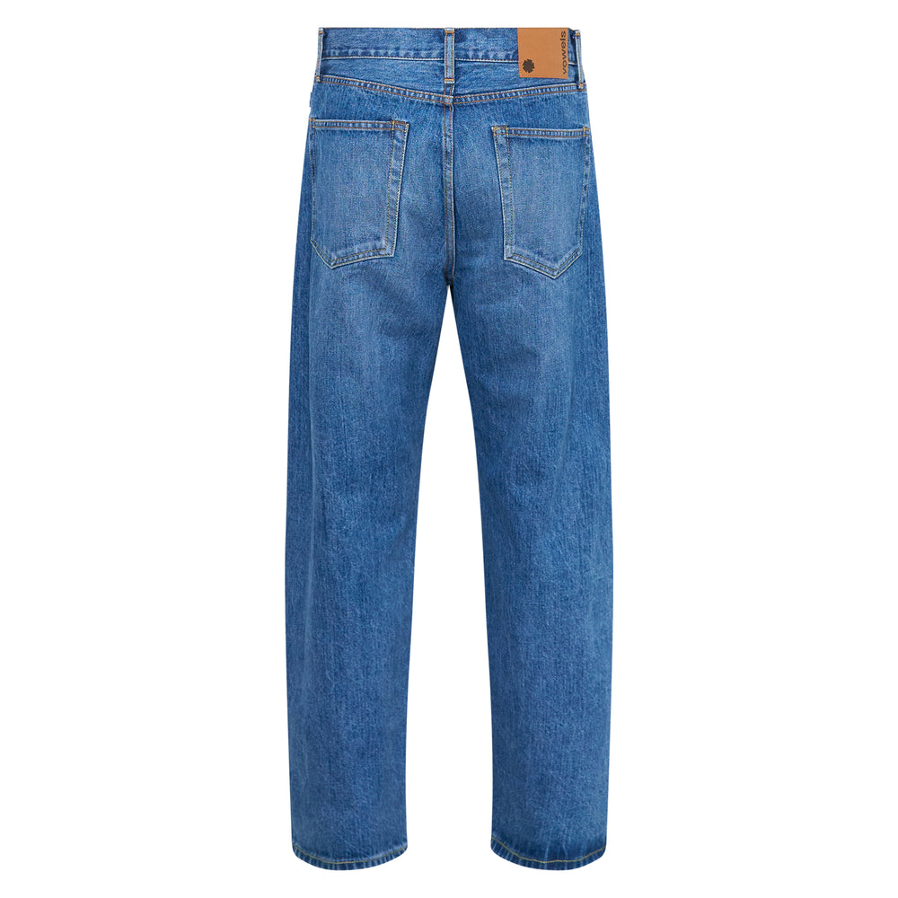 Vowels Baggy Patchwork Jeans in mid-wash blue denim with eclectic mixed-fabric patch panels of striped shirting, checked cloth, and dark denim across the thighs, shown flat against a white background - view 2