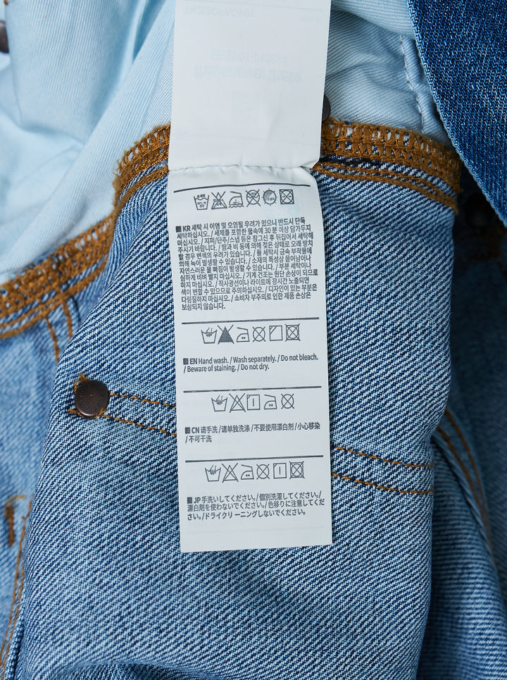 thisisneverthat Denim Double Knee Pants in heavy vintage wash indigo with ochre distressing, double-knee reinforced panels, carpenter utility detailing, and a relaxed wide-leg silhouette — front view - view 4