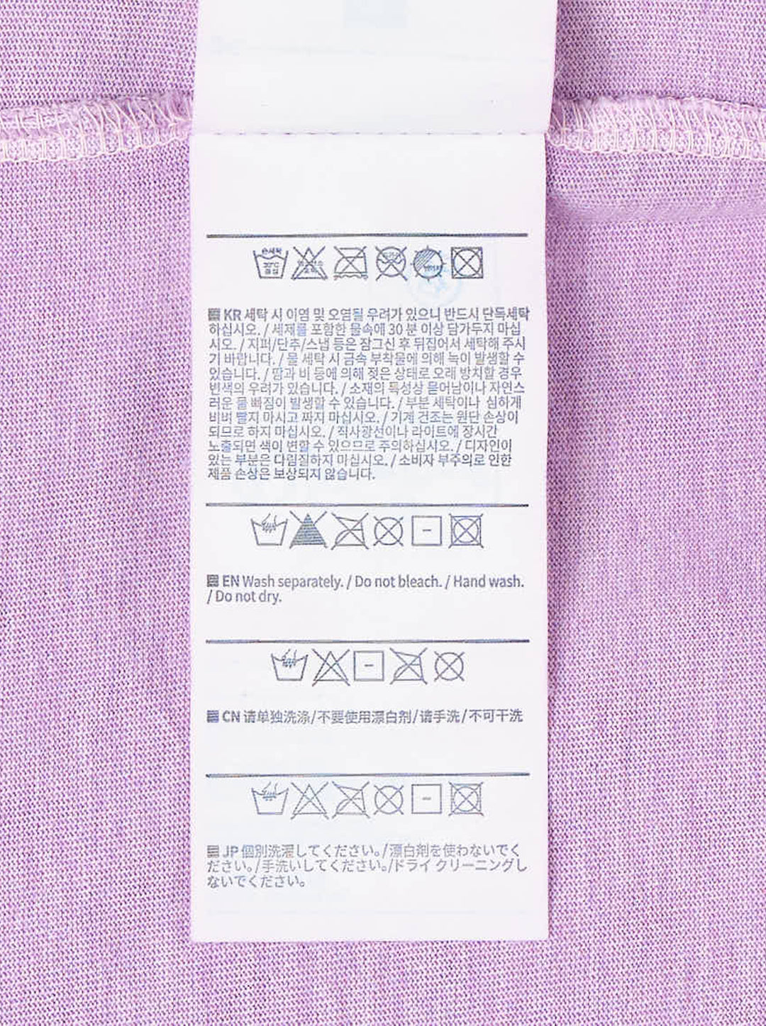 thisisneverthat From the World Tee in acid-washed purple with vertical cyan 'World' graphic and signature script branding on the chest - view 3