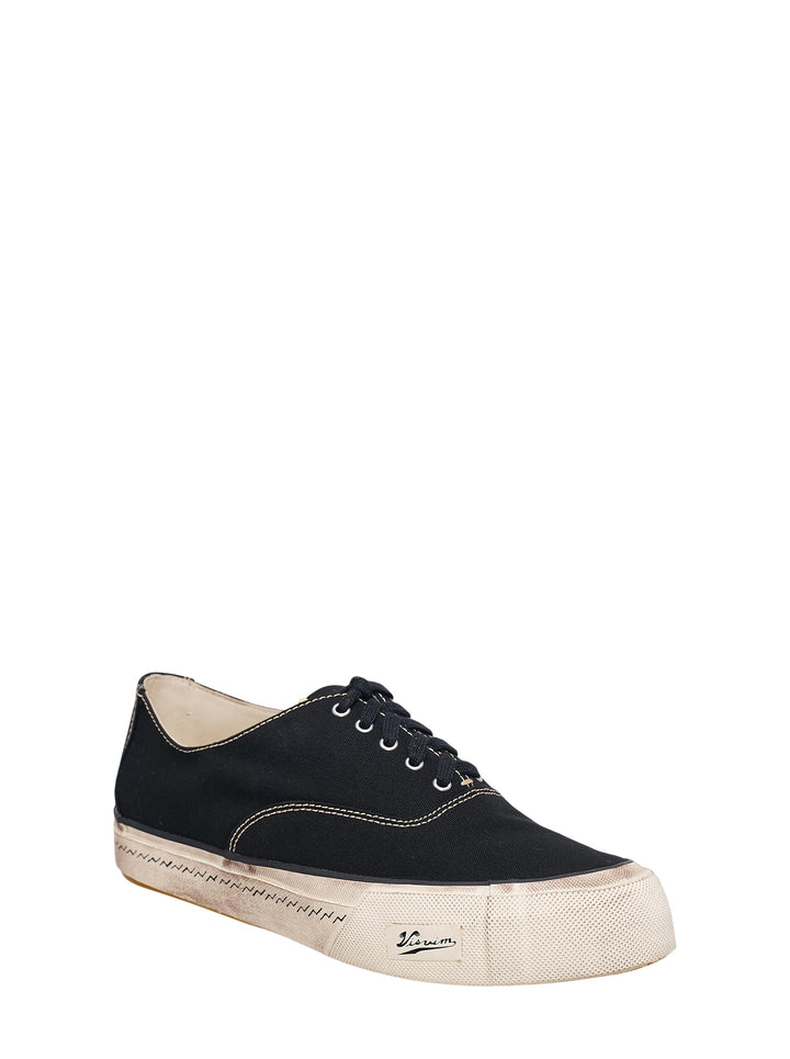visvim Logan Deck Lo black canvas sneaker with contrast stitching and distressed off-white sole, side view - view 2