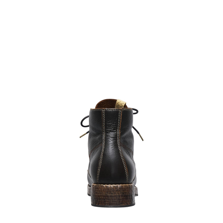 visvim Virgil Folk lace-up boot in black pebbled vegetable-tanned leather, featuring brass eyelets, contrast stitching, and a textured stacked leather sole, shown in profile - view 3