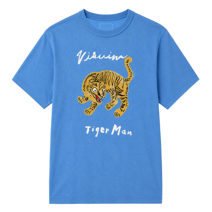 visvim Tiger Man Jumbo Short Sleeve Tee in cornflower blue, featuring a hand-drawn style striped tiger graphic with white script lettering above and below, laid flat on a white background