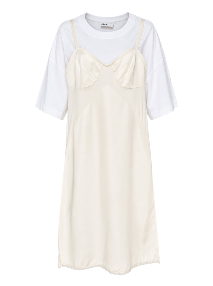 Vaquera layered dress combining an oversized white T-shirt with a cream satin bustier slip dress with lace hem