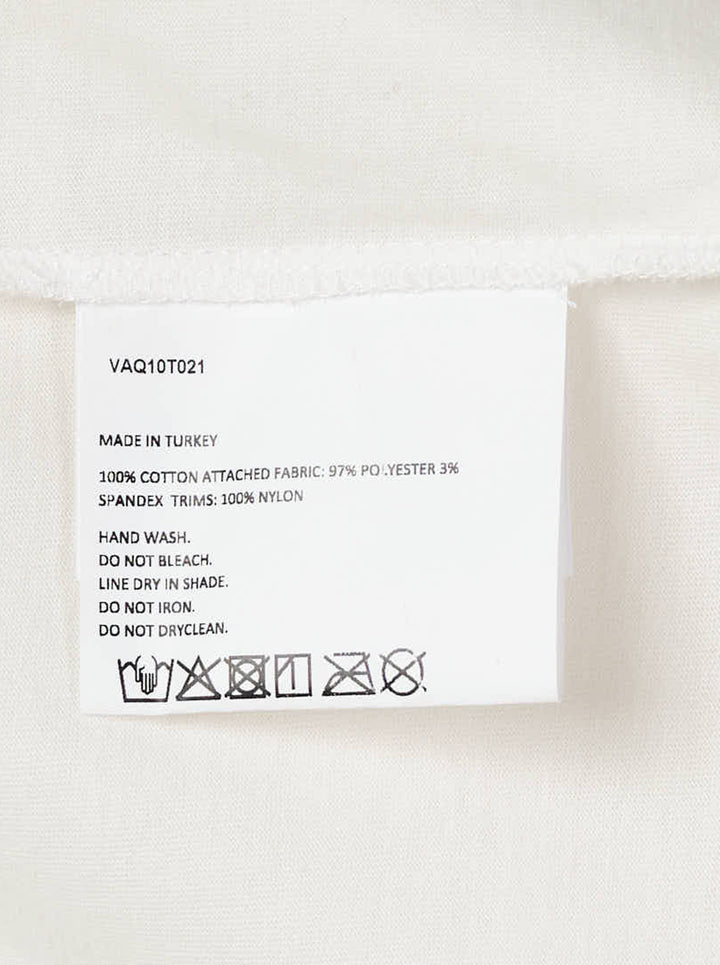 Vaquera layered dress combining an oversized white T-shirt with a cream satin bustier slip dress with lace hem - view 3