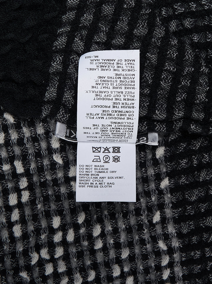 Issey Miyake Bumpy Wool Stole in monochrome black and grey check weave with dimensional textured surface, bold black stripe accents, and raw fringe hem edges - view 2