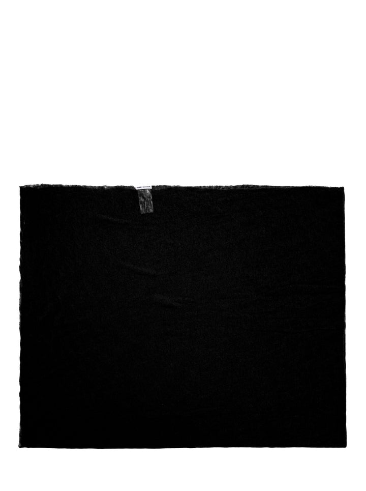 Issey Miyake black cashmere knit stole laid flat, showing frayed edges and woven brand label
