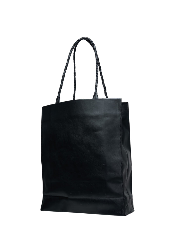 Issey Miyake black textured leather tote bag with braided handles and embossed logo, shot against a white background - view 2