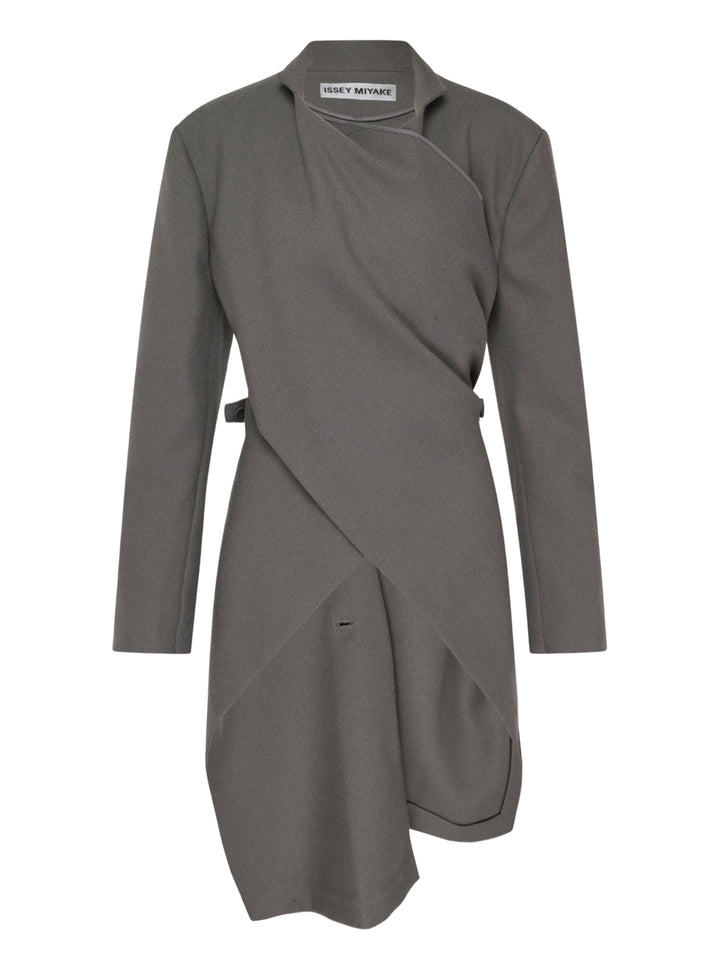 Issey Miyake CALLIGRAPH grey long-sleeve wrap jacket with asymmetric diagonal drape panels, side buckle fastening, and curved hem, displayed flat on white background