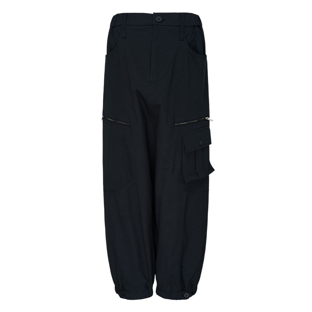 Issey Miyake Grainy Pants in black — wide-leg woven cargo trousers with zip thigh pockets, flap cargo pocket, and button-fastened ankle cuffs