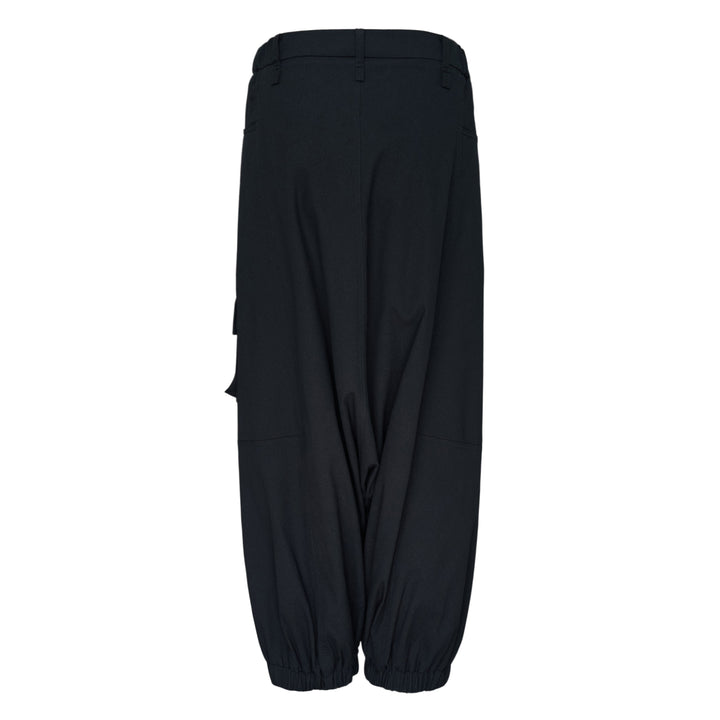 Issey Miyake Grainy Pants in black — wide-leg woven cargo trousers with zip thigh pockets, flap cargo pocket, and button-fastened ankle cuffs