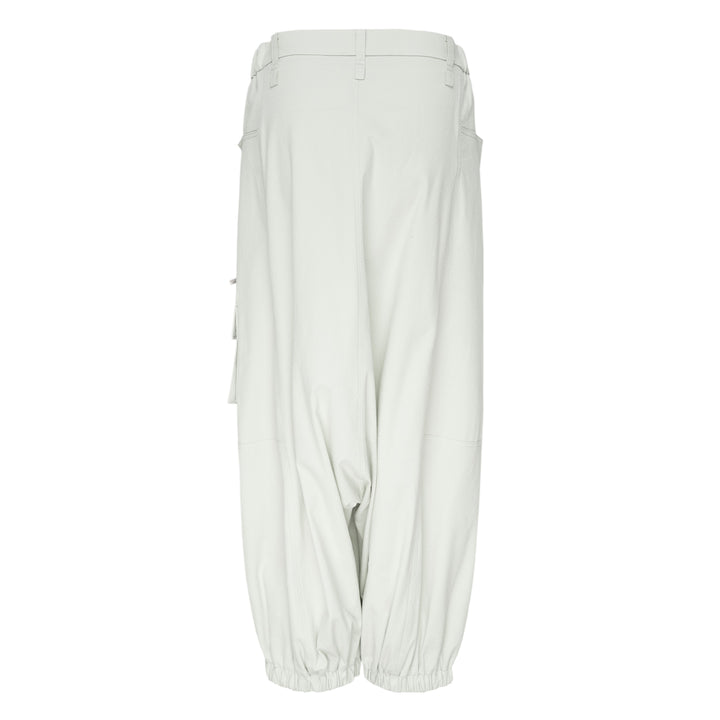 Issey Miyake Grainy Pants in black — wide-leg woven cargo trousers with zip thigh pockets, flap cargo pocket, and button-fastened ankle cuffs