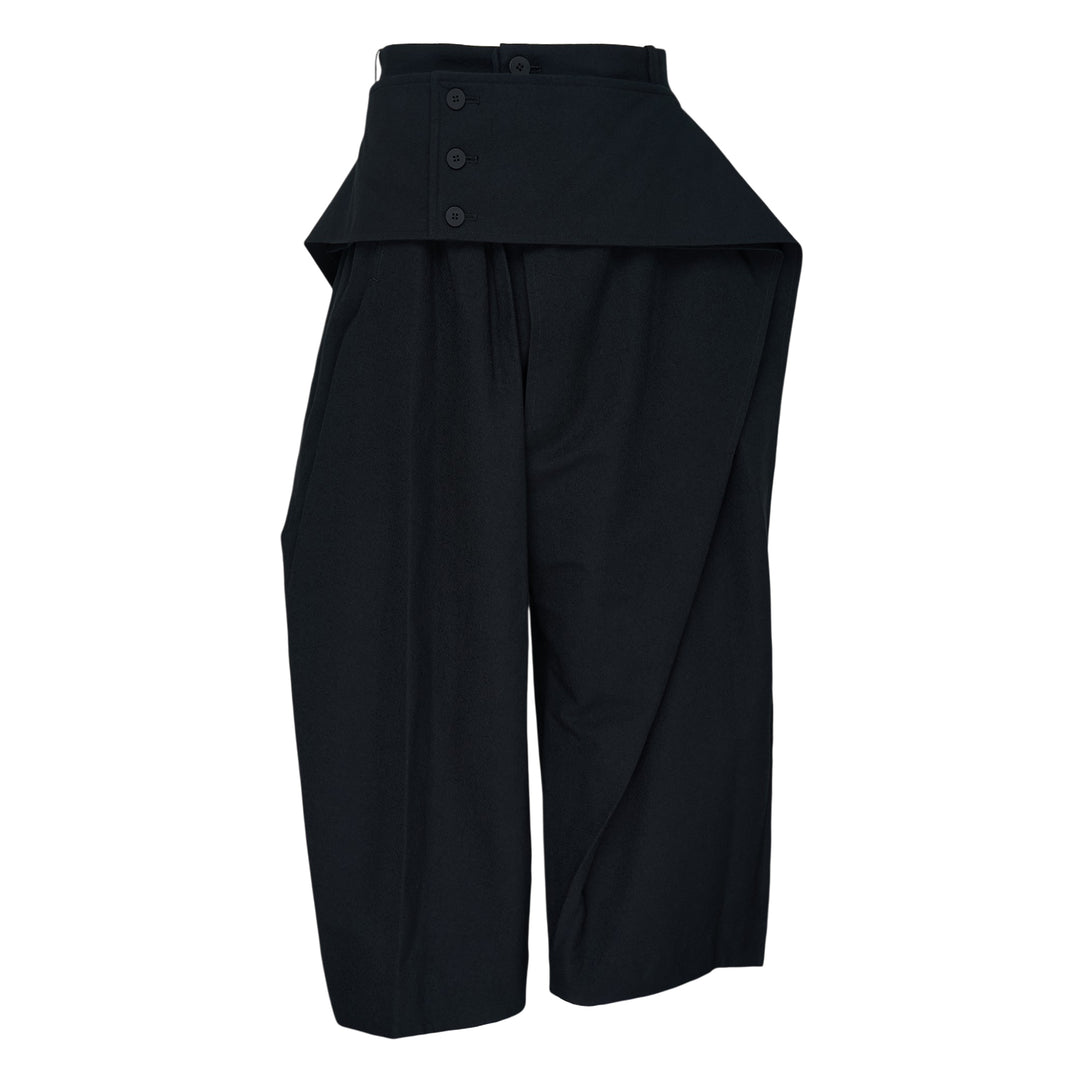 Issey Miyake Grainy Pants in black — wide-leg woven trousers with a fold-over waistband, three-button detail, and asymmetric overlay panel