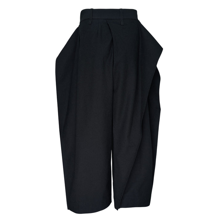 Issey Miyake Grainy Pants in black — wide-leg woven trousers with a fold-over waistband, three-button detail, and asymmetric overlay panel