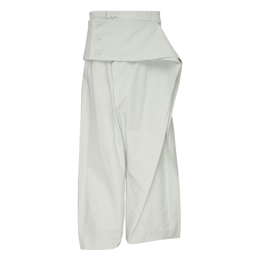 Issey Miyake Grainy Pants in black — wide-leg woven trousers with a fold-over waistband, three-button detail, and asymmetric overlay panel