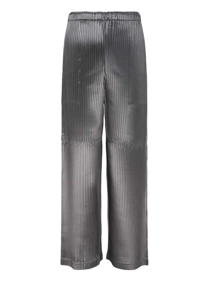 Issey Miyake glossed panels pleated pants in a metallic grey finish with an elasticated waist and wide-leg silhouette, shown from the front
