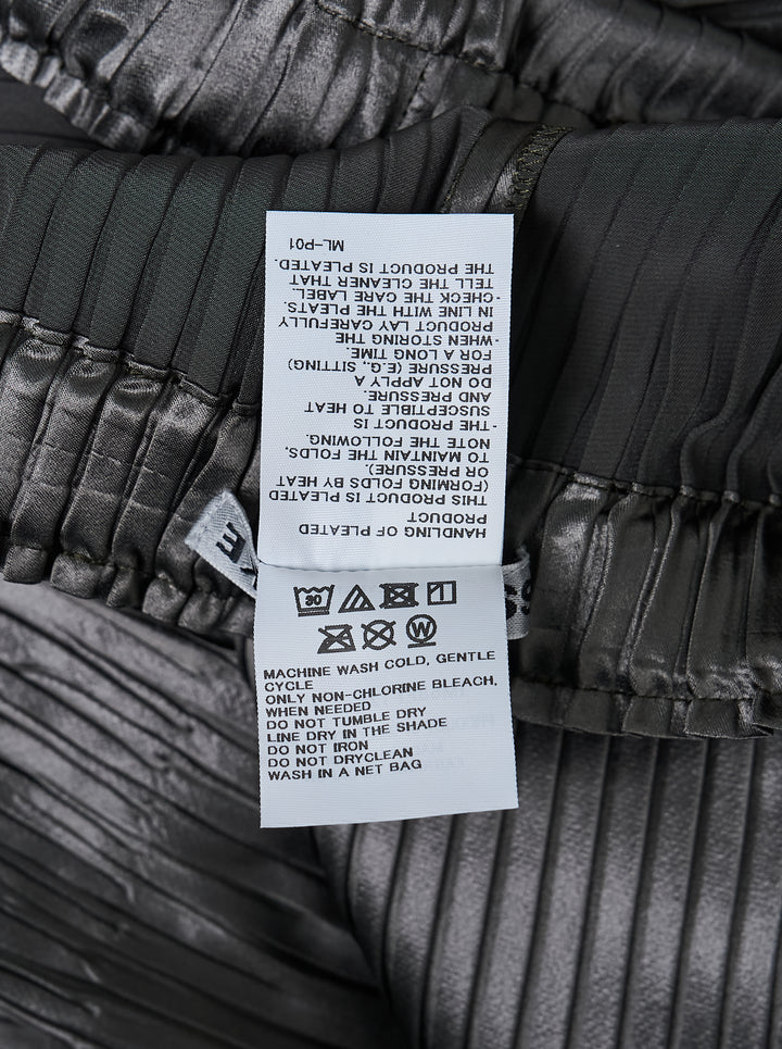 Issey Miyake glossed panels pleated pants in a metallic grey finish with an elasticated waist and wide-leg silhouette, shown from the front - view 3