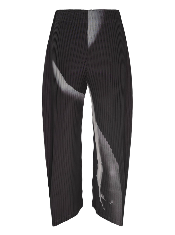 Issey Miyake Hands of Lover Pleats wide-leg cropped pants in black with abstract diagonal grey gradient print across pleated fabric, shown flat on white background - view 2