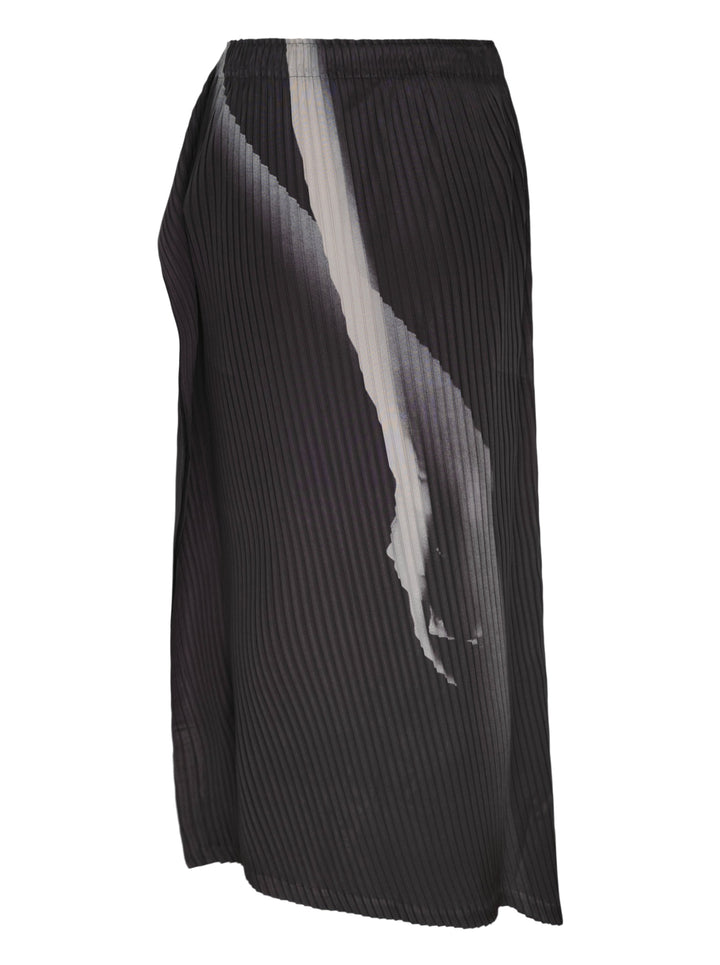 Issey Miyake Hands of Lover Pleats midi skirt in dark charcoal with abstract inkwash print and asymmetric wrap-front drape, shown in profile against a white background - view 2