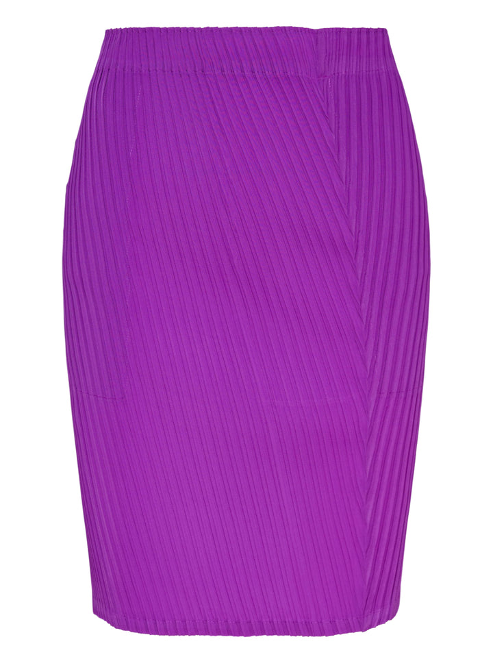 Issey Miyake Tubular Pleated Skirt in vivid purple, featuring a directional chevron pleating pattern and elasticated waistband, displayed flat against a white background