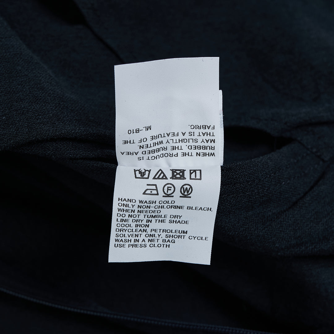 Issey Miyake ALLOW sleeveless woven midi dress in deep navy with asymmetric hem and sculptural silhouette