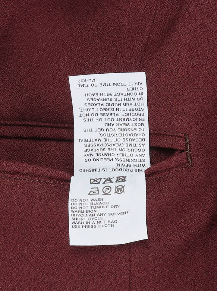Issey Miyake burgundy tunic with funnel neck, structured shoulders, chest welt pocket and two flap pockets, shown from the front - view 3