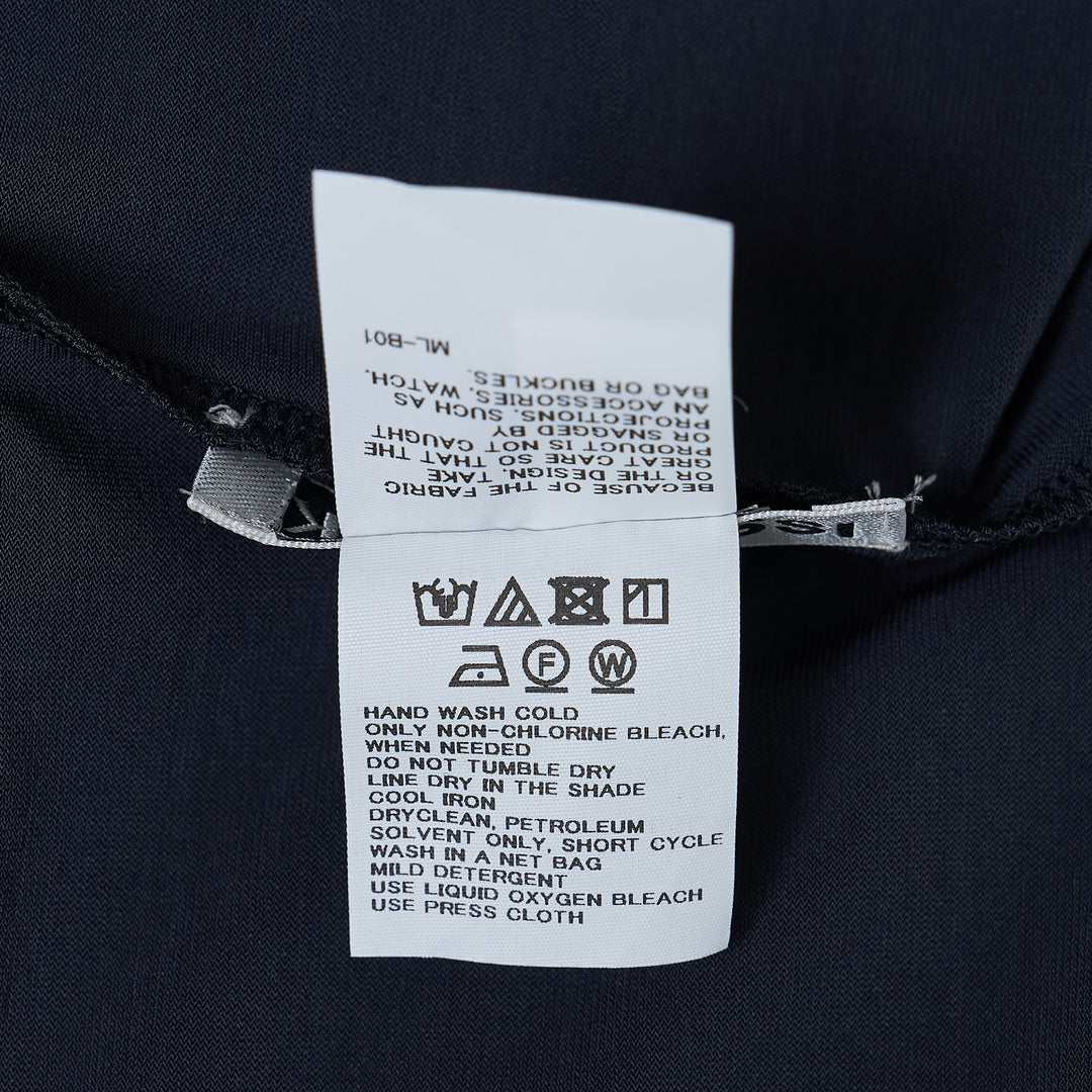 Issey Miyake Drape Jersey Knit Pants in black, wide-leg silhouette with mixed-texture ribbed panel and elasticated waistband, flat lay on white background