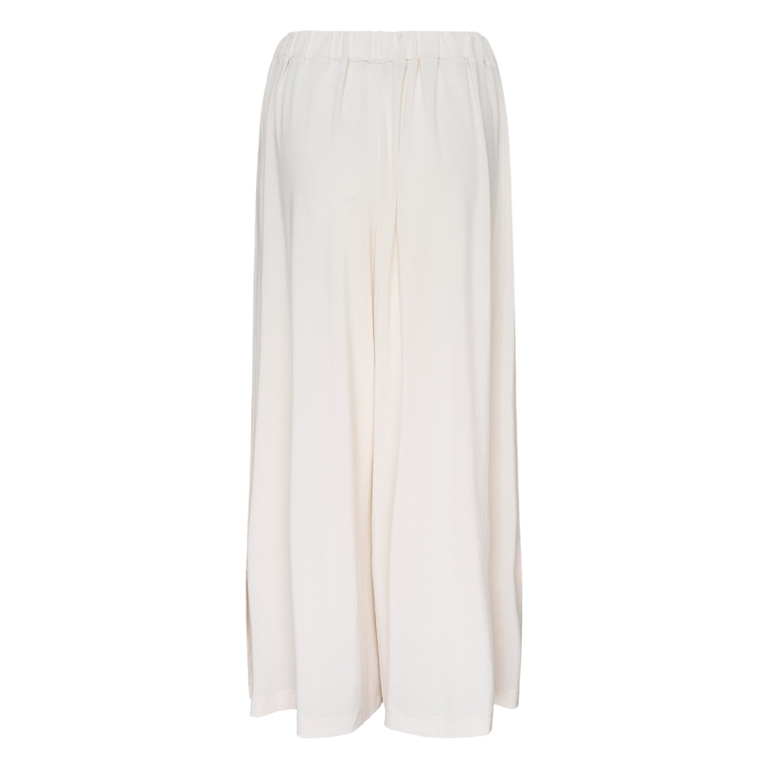 Issey Miyake Drape Jersey Knit Pants in black, wide-leg silhouette with mixed-texture ribbed panel and elasticated waistband, flat lay on white background
