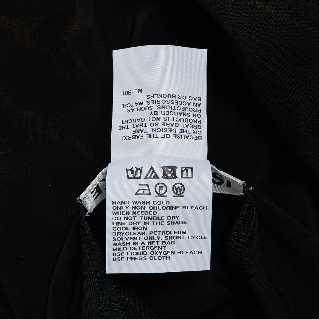 Issey Miyake Drape Jersey Knit Dress in black, sleeveless with V-neckline and centrally pleated drape, relaxed cocoon silhouette, midi length, flat lay on white background