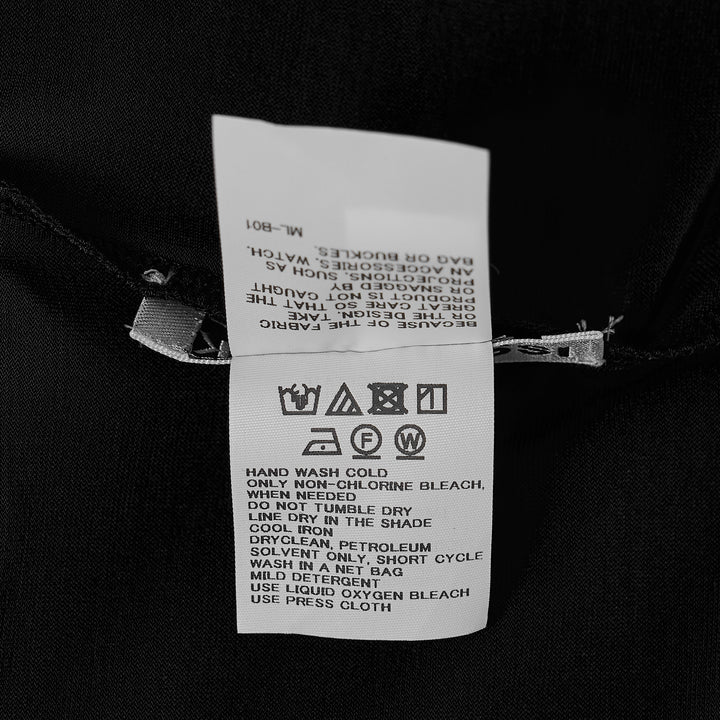 Issey Miyake Drape Jersey Cardigan in black, featuring a single-button front closure, draped bodice, long sleeves, and an asymmetric handkerchief hem with cascading pointed ends