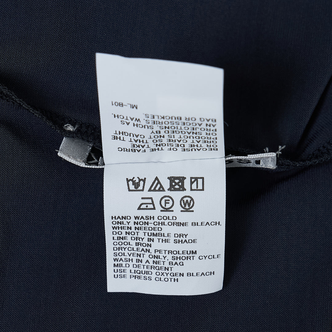 Issey Miyake Drape Jersey Cardigan in black, featuring a single-button front closure, draped bodice, long sleeves, and an asymmetric handkerchief hem with cascading pointed ends