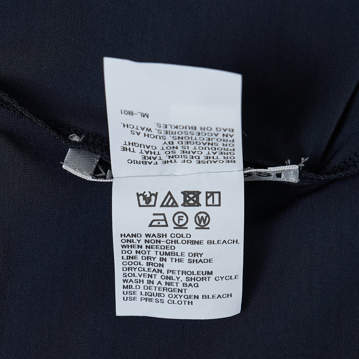 Issey Miyake Drape Jersey Cardigan in black, featuring a single-button front closure, draped bodice, long sleeves, and an asymmetric handkerchief hem with cascading pointed ends