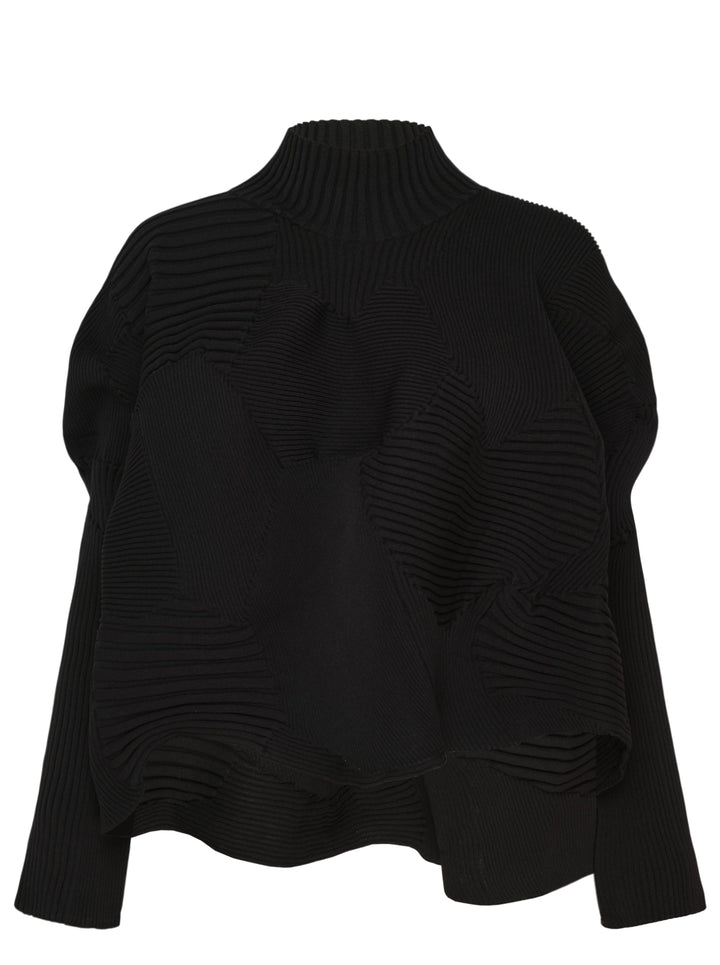 Issey Miyake Kone sculptural black ribbed knit top with directional 3D rib panels, mock-neck collar, oversized silhouette, and asymmetric curved hem