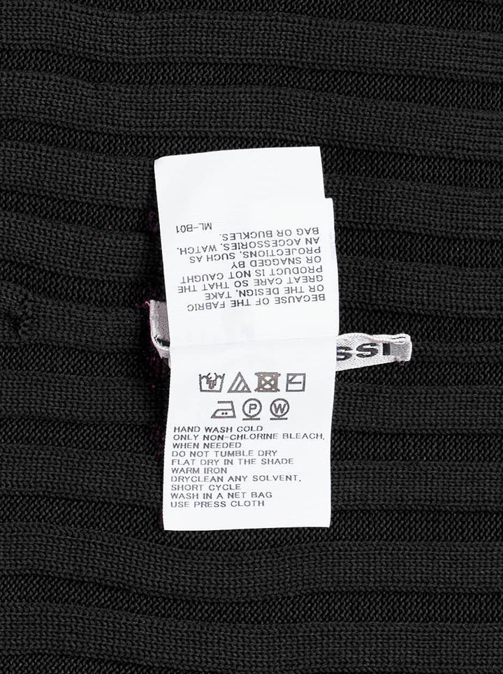Issey Miyake KONE KONE black knit top with multi-directional ribbed panels, asymmetric pointed hem, and long sleeves — rear view on white background - view 3