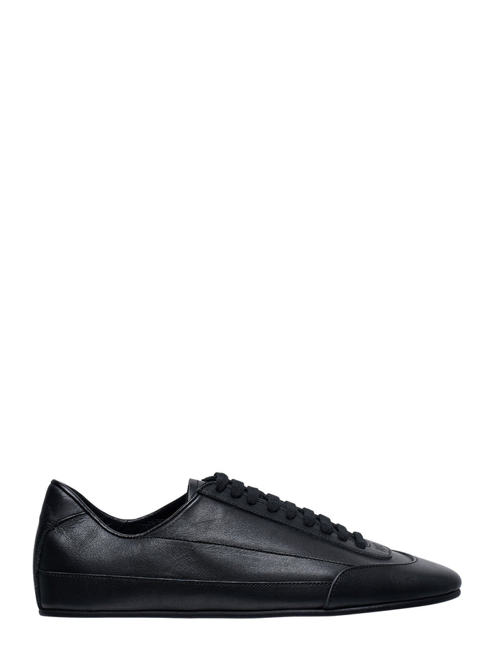 IM Men Flipper low-top sneaker in all-black smooth leather with tonal laces and slim rubber sole, side profile view
