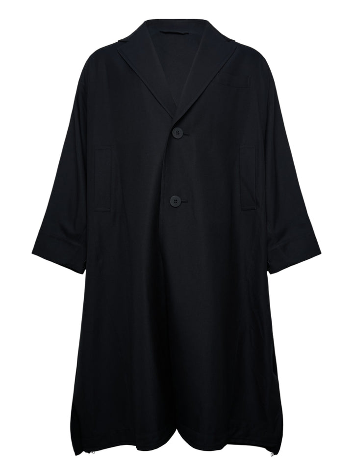IM Men Breeze Drape Coat in black — oversized A-line silhouette with notched lapels, two-button closure, patch pockets, three-quarter sleeves, and hem zip vents