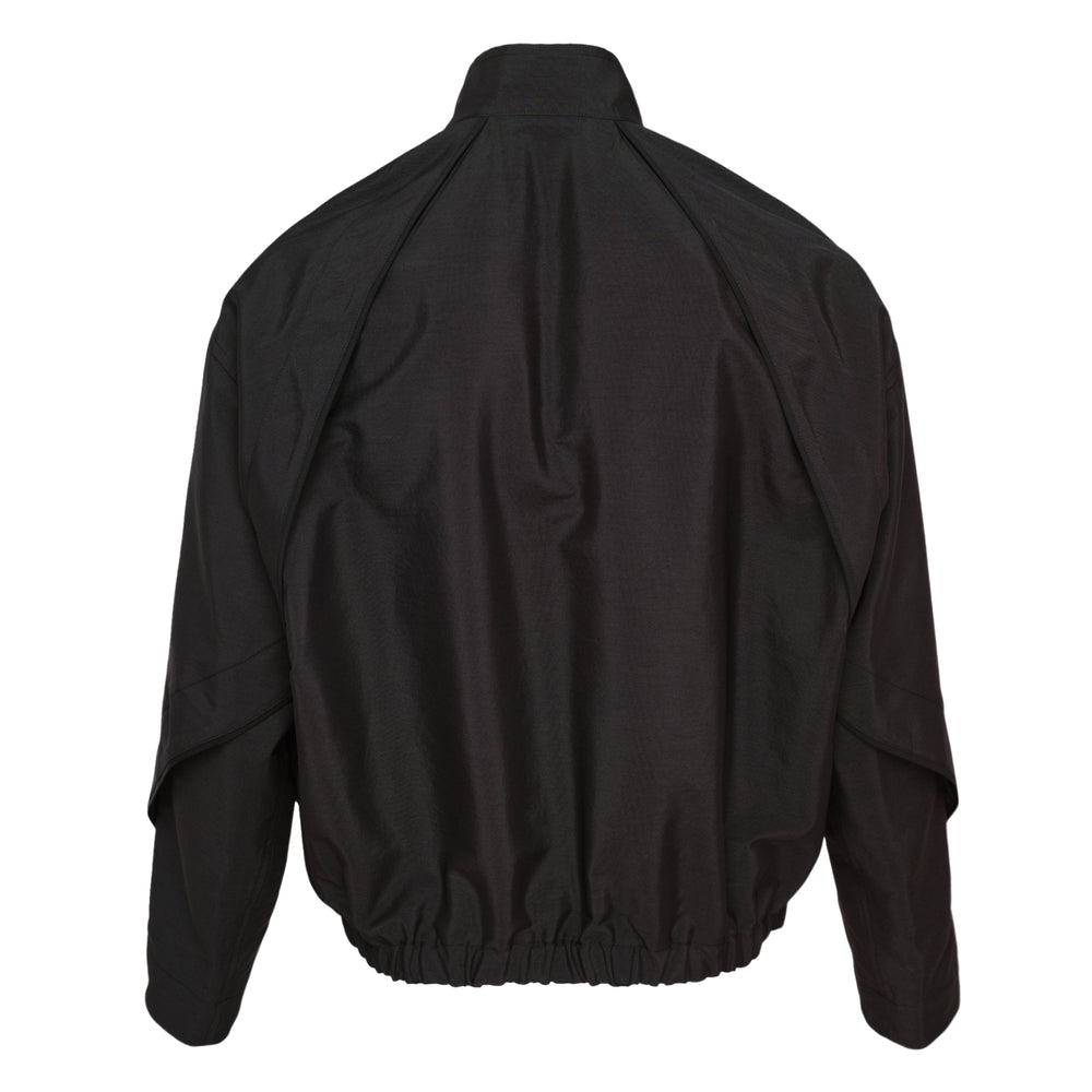 IM MEN FLUENT Blouson in black, featuring a concealed zip closure, high stand collar, dropped shoulders, and elasticated hem, displayed flat on a white background