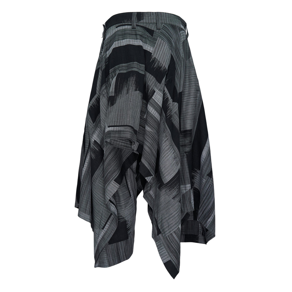 IM MEN Kasuri woven pants in black and grey abstract ikat-inspired brushstroke print, featuring a high waistband, dramatically draped voluminous silhouette, and asymmetric hemline