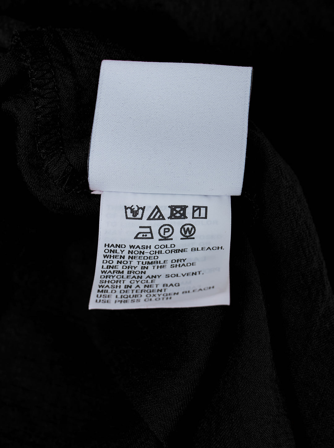 IM Men Cotton Yak Woven Pants in black — high-rise pleated drop-crotch trousers with a cropped tapered hem, front view on white background - view 3