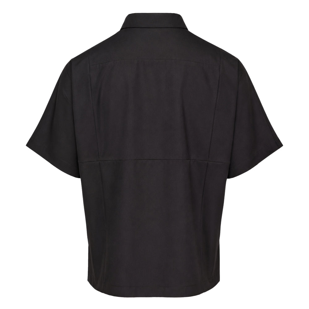 IM MEN Compact Shirt in black — boxy short sleeve silhouette with geometric panel seaming, camp collar, and tonal snap-button placket