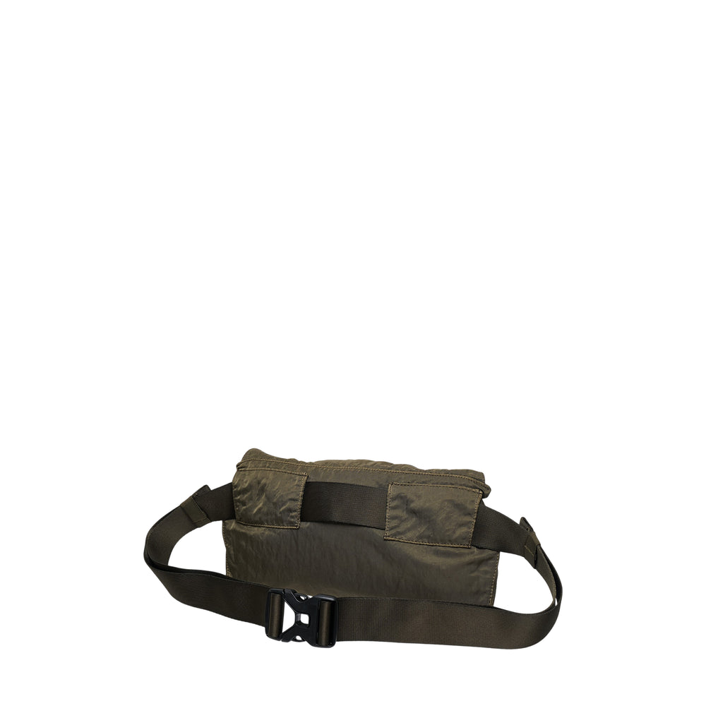C.P. Company Nylon Lens Waist Bag in olive green with snap-flap closure, adjustable belt strap, and rubberised NFC Lens badge on the front panel