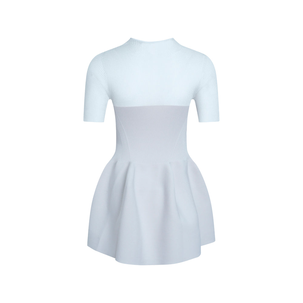 CFCL Lucent Décolletage Short Sleeve Knit Top in pale blue with ribbed bodice, diagonal seaming, and sculptural voluminous peplum hem, shown flat on white background - view 2