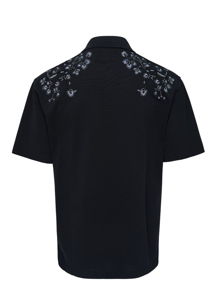 Black Amiri polo shirt with grey eagle and floral embroidery across the shoulders and an embroidered script logo on the chest - view 2