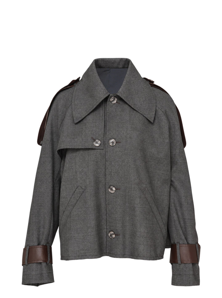 Sonia Carrasco cropped grey trench jacket with oversized pointed collar, button front and brown leather-look straps at the shoulders and cuffs