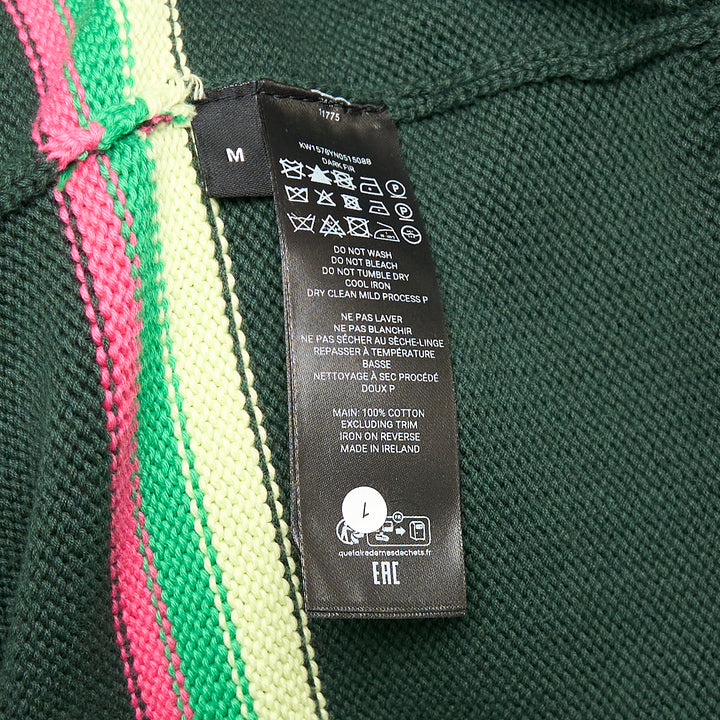 JW Anderson forest green cotton Sheep Jumper with raised intarsia lamb appliqué at the chest and pink, cream, and green stripe bands across the body and sleeves